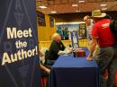 Glen Popiel, KW5GP, at the "Meet the Author" table at the ARRL EXPO. [Jen Glifort, photo]